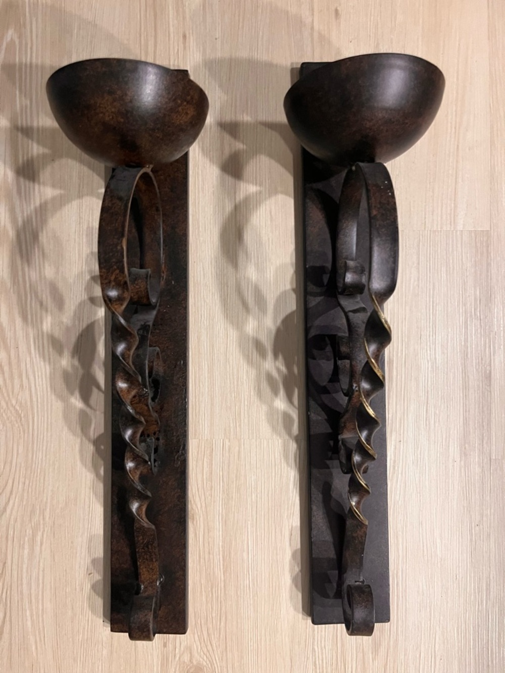 Two Hand-Forged Style Metal Wall Sconces with two sphere shaped candles